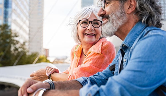 An older couple sitting together in a city